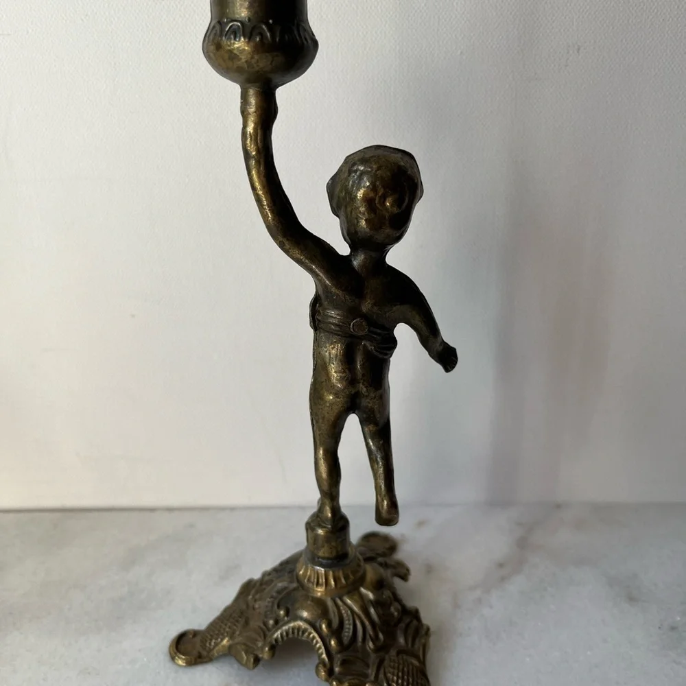 Antique cherub figurine candle holder